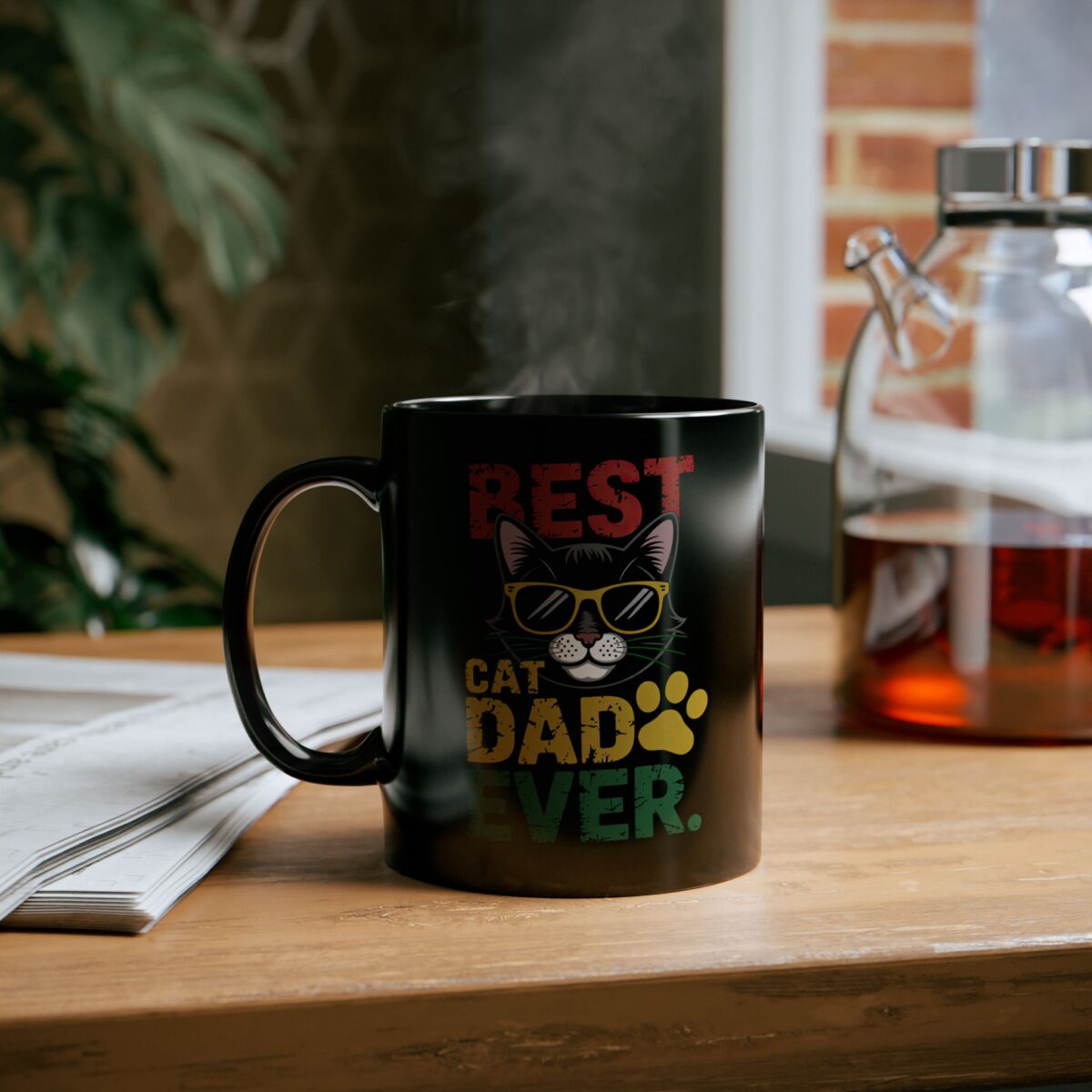A black mug with a graphic that says 'BEST CAT DAD EVER' with a cartoon cat wearing sunglasses and a paw print.