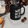 Black ceramic mug with white text that reads