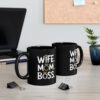 Black ceramic mug with white text reading