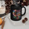 Black mug with a colorful sunflower graphic and text that reads 