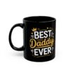 A black mug with a white and gold text design that reads 