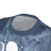 Dark blue t-shirt with a celestial pattern featuring moon phases and stars scattered across the fabric.