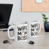 White ceramic mugs with black text reading