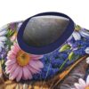 All over print sublimation tee featuring a cat face graphic surrounded by vibrant pink and white daisies and blue wildflowers.