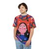 Red all over print t-shirt, abstract face graphic, long black hair, pink cheeks, blue neckline, white stars, red butterflies, blue, pink, green, black abstract flowing lines, seamless design.