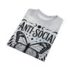Black and white patterns including a monarch butterfly, stars, moons, and leaves cover this all over print t-shirt, with text reading