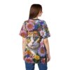 All over print sublimation tee, large tabby cat face, bright green eyes, surrounded by pink, purple, yellow daisy-like flowers, seamless print.