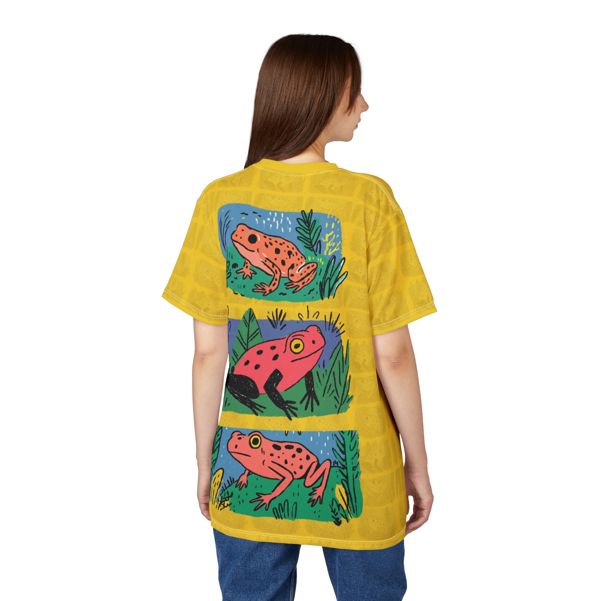 Yellow with a subtle grid pattern and repeating frog motifs cover this graphic t-shirt, featuring three illustrated frogs in different panels.