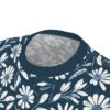 White and blue daisy-like flowers and leaves on a dark blue background cover this seamless pattern tee.