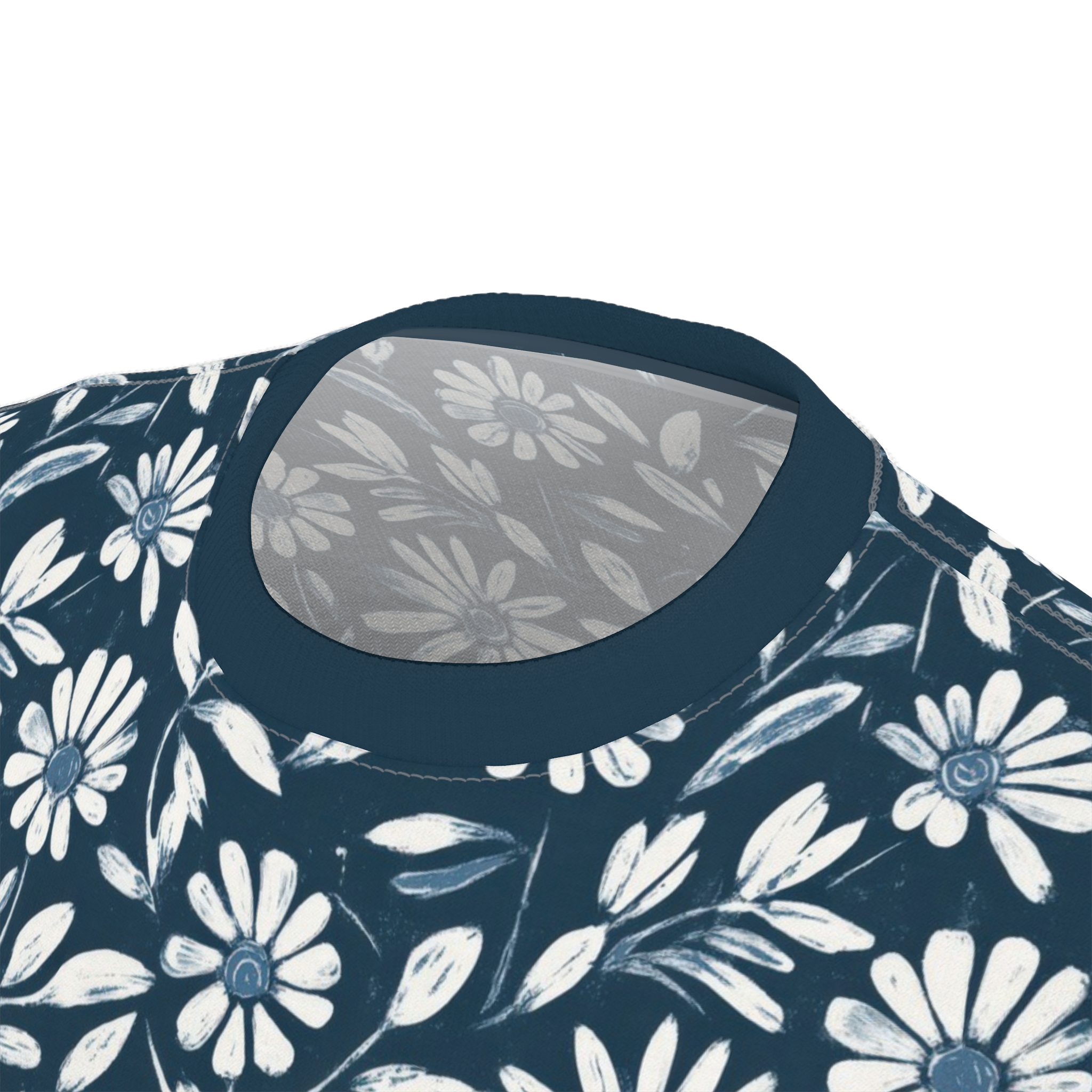 White and blue daisy-like flowers and leaves on a dark blue background cover this seamless pattern tee.