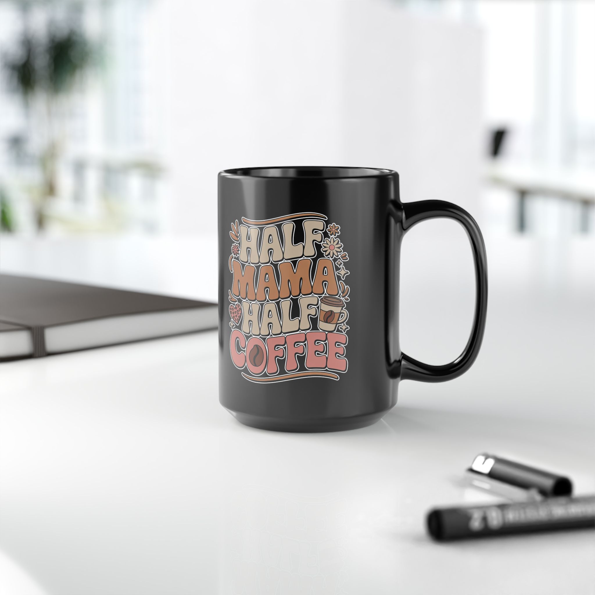 Black mug with "Half Mama Half Coffee" text in retro font, featuring coffee cup and floral graphics.