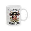 White ceramic mug with a cartoon cow graphic and the text 