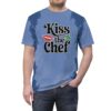 Blue and lighter blue abstract brushstroke patterns cover this patterned tee shirt, featuring the text 
