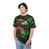 Dense green leaves, dark shadows cover this sublimation graphic tee, depicting a majestic brown eagle profile.