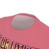 Pink t-shirt with black and yellow bold text graphics and a seamless pattern tee design.