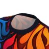 Vibrant abstract all over print sublimation tee featuring swirling flame-like graphics in blue, red, orange, and yellow hues.