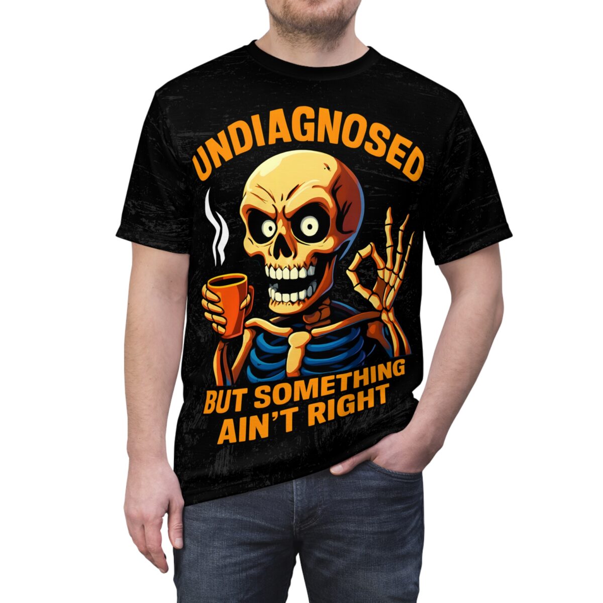Black all over print, grunge texture, skeleton graphic, coffee cup, 'OK' gesture, orange 'UNDIAGNOSED BUT SOMETHING AIN'T RIGHT'.