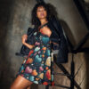 Skater dress with all over print of stylized hearts and floral motifs in vibrant blues, oranges, and reds on a dark background.