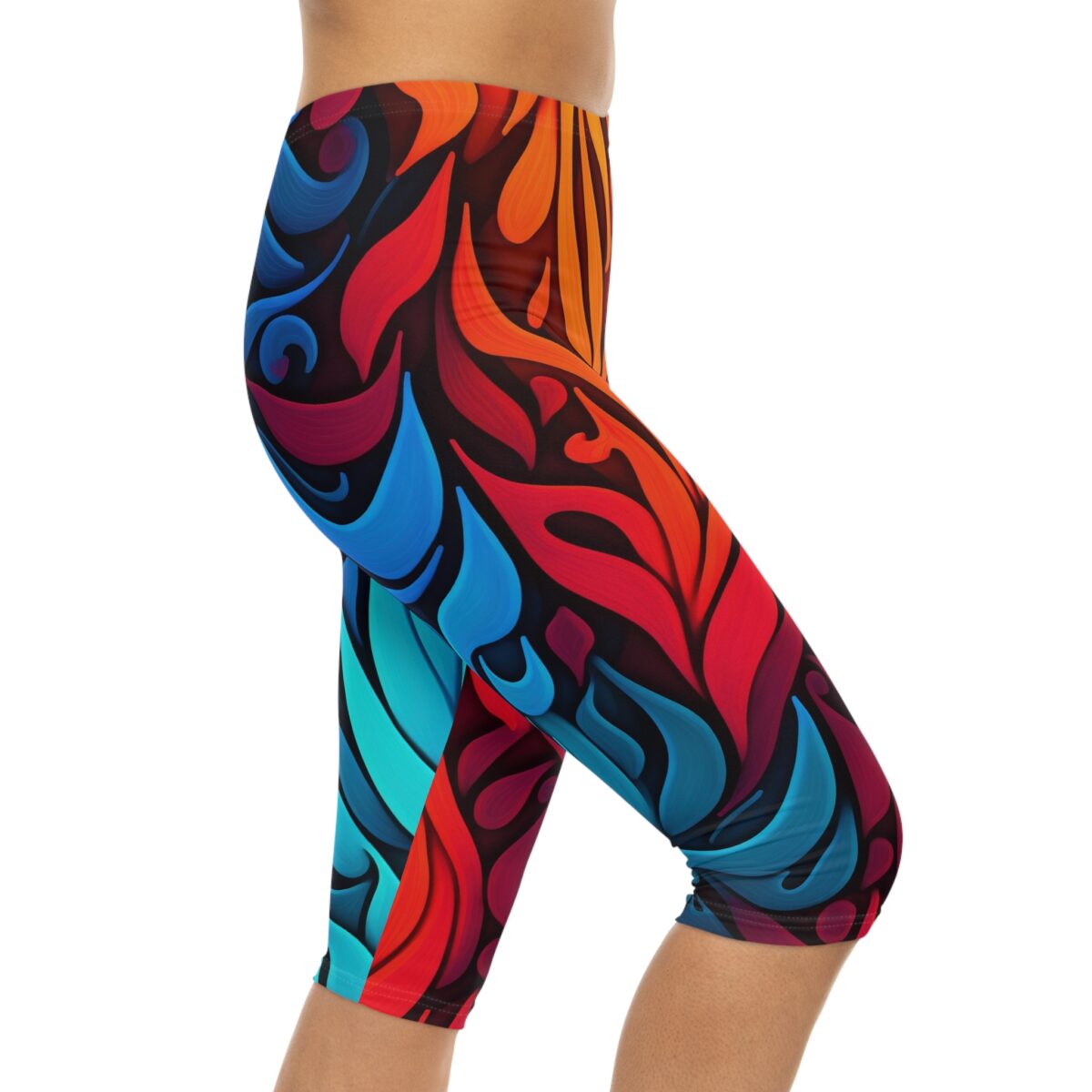 Fluid, multi-color abstract patterns in shades of red, orange, blue, and teal create a lively design on these capri leggings.