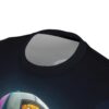 A cartoon monkey wearing a colorful baseball cap is depicted across this seamless pattern tee, against a dark, gradient background.