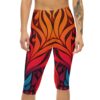 Bold red, orange, and blue floral motifs fill these capri leggings with a dark background.