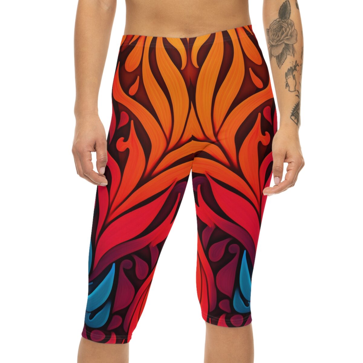 Bold red, orange, and blue floral motifs fill these capri leggings with a dark background.