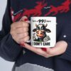 White ceramic mug with a funny cow graphic and text 'There's a 99% chance I DON'T CARE'.