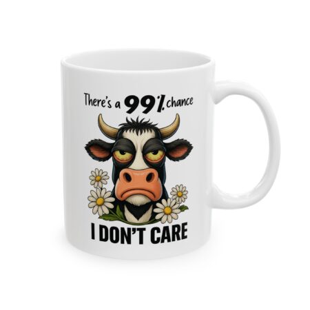 White ceramic mug featuring a grumpy cow illustration with daisies and the text "There's a 99% chance I DON'T CARE".
