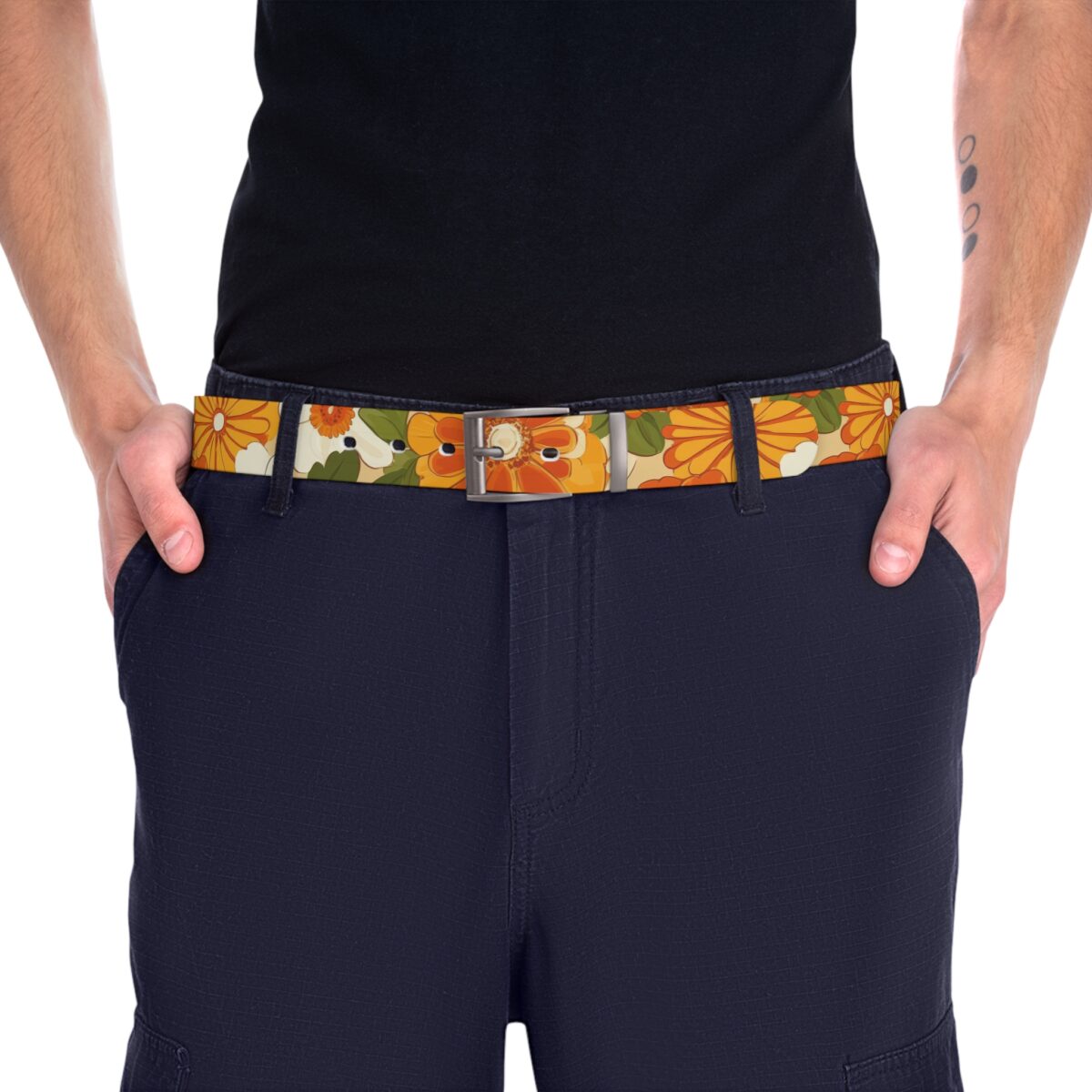 Retro floral belt featuring orange, yellow, and cream flowers with green leaves on a tan background. Vintage pattern accessory.