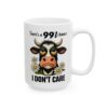 A white ceramic mug with a grumpy cow illustration and text.