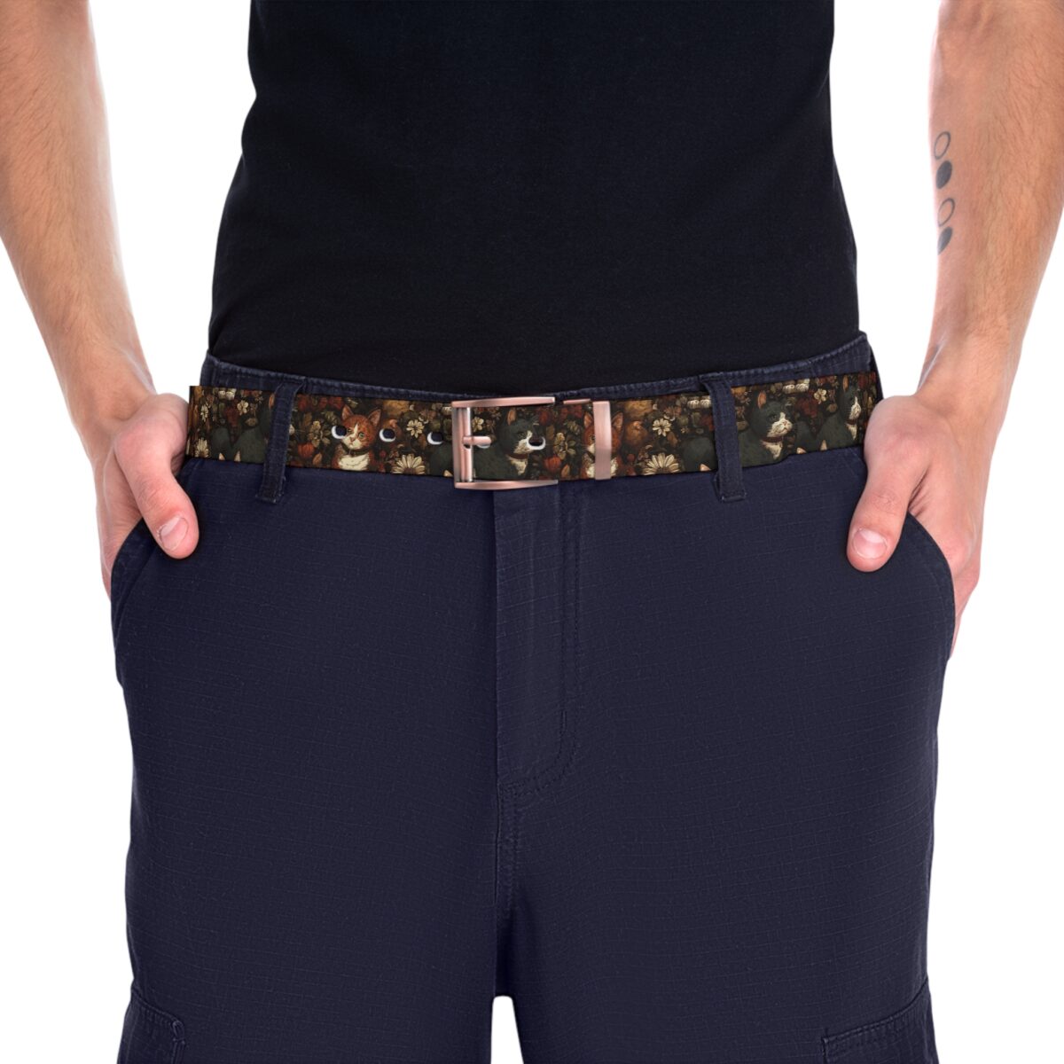 Vintage cat floral pattern printed belt with a metallic buckle set against dark blue pants.