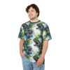 Watercolor green dinosaurs with open mouths and sharp teeth cover this 3D graphic t-shirt in a repeating pattern.
