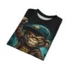 A fierce monkey in a leather jacket and teal cap with glowing yellow eyes covers this graphic tee shirt with an urban, punk vibe.