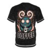 Black marble texture with a turquoise monster, swirls, stars, and the word 'COFFEE' adorn this graphic tee.