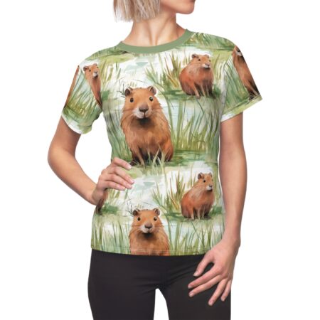 All over print t-shirt featuring a seamless watercolor pattern of cute capybaras sitting in tall green grass by water.