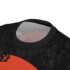 Black marbled texture, orange sun, and pale pink flowers cover this patterned tee shirt with a tropical vibe.