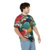 Crimson, teal, and gold chrysanthemum-like flowers with green leaves cover this oversized full print tee, creating a vibrant botanical garden against a white background.