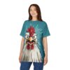 Teal with speckles and radiating lines cover this graphic streetwear tee, featuring a cartoon chicken with wide eyes and an open beak.
