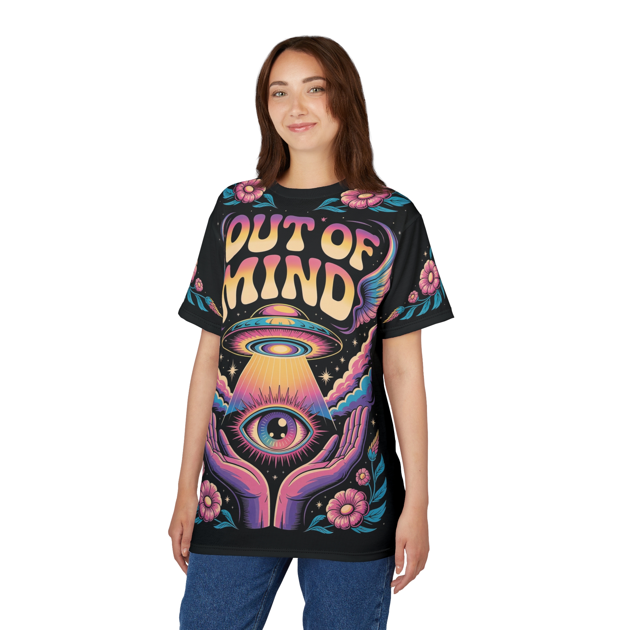 Vibrant pink and yellow 'OUT OF MIND' text, a flying saucer beaming light onto an eye, and floral patterns cover this seamless pattern tee.