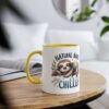 White ceramic mug with yellow handle and rim, featuring a cute sloth graphic and the text 