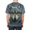 Gray and black swirling patterns cover this patterned tee shirt, showcasing a realistic wolf's face with piercing yellow eyes.