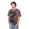 Red roses, green leaves, and intricate patterns cover this patterned tee shirt, featuring a black cat with emerald eyes and a cube-shaped head.