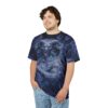 Deep blues, purples, and swirling white patterns cover this sublimation graphic tee, depicting a fierce, horned demon with glowing purple eyes and a menacing grin.