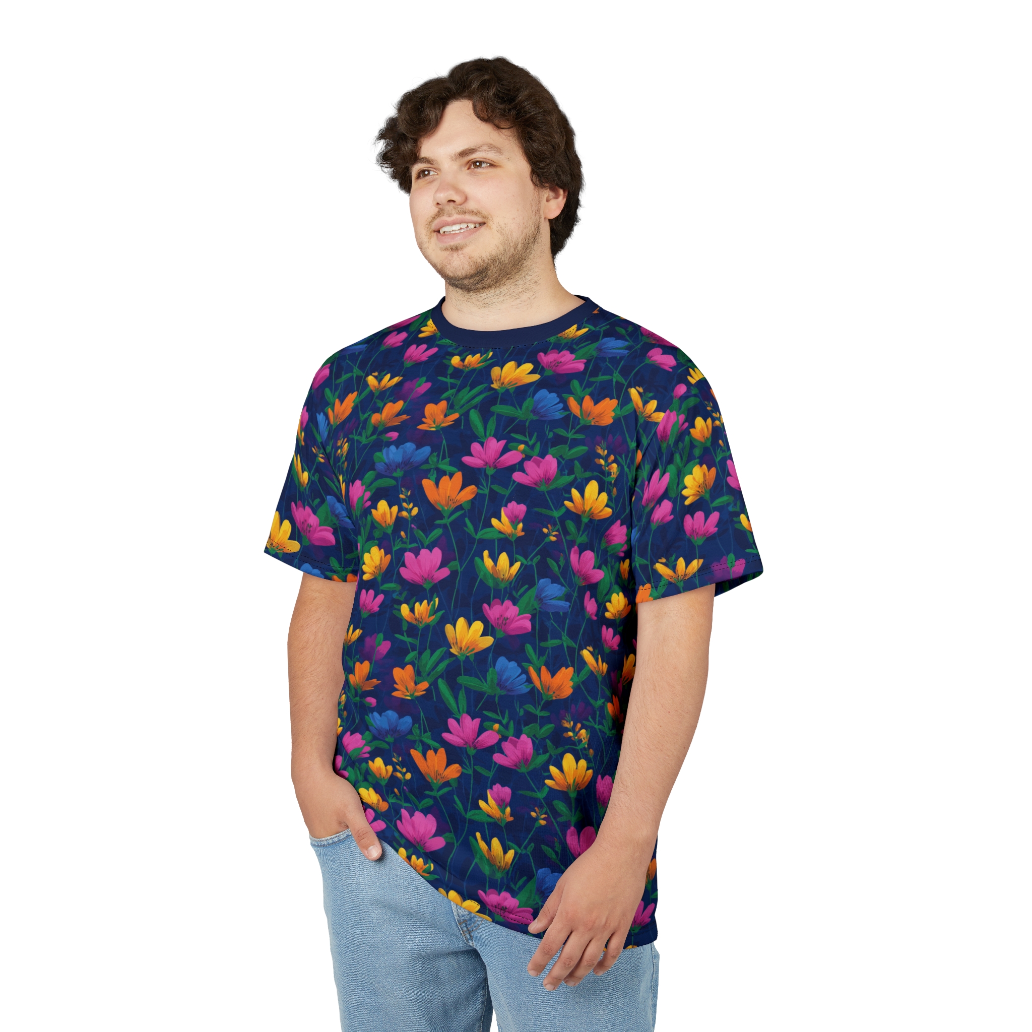 Bright pink, orange, yellow, and blue flowers with green leaves cover this all over print t-shirt, set against a dark navy background.