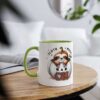 White coffee mug with a green handle and rim, featuring a cute sloth peeking out of a pumpkin.