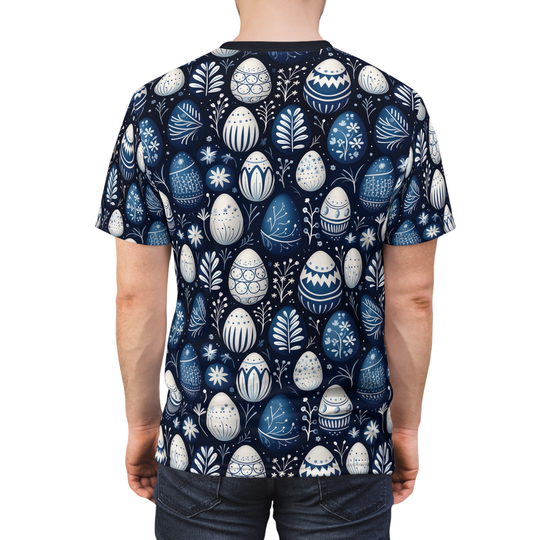 Blue and white Easter eggs with floral and geometric patterns cover this all over print t-shirt, with delicate white leaves and flowers scattered throughout on a dark navy background.