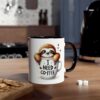 A white ceramic mug with a black rim and handle, featuring a cartoon sloth peaking out of a coffee cup that says 