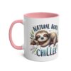 White ceramic mug with a pink handle and rim, featuring a cute sloth napping on a branch with colorful text.