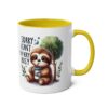 White ceramic mug with yellow handle and interior, featuring a cartoon sloth under a tree with text reading 