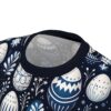 Blue and white floral and Easter egg designs cover this patterned tee shirt, with delicate sprigs and flowers scattered throughout.
